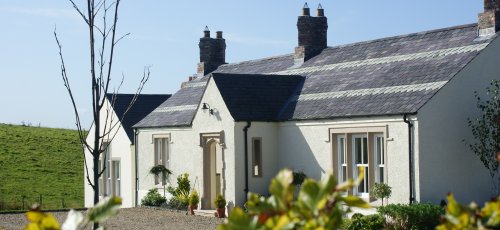 Timeless reclaimed roof slates and bricks by Wilsons Conservation Building Products.