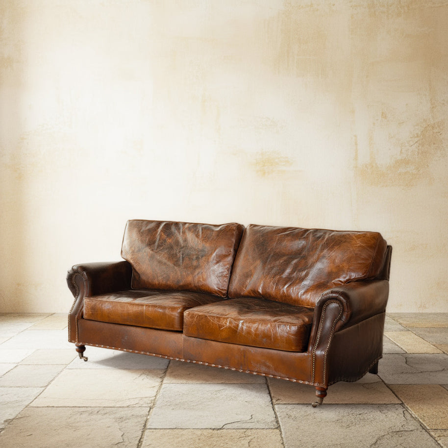 Vintage style leather sofa on castor wheels
