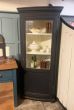 Tall corner cupboard with bow fronted glass 