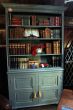 A Beautiful Hand Made Painted Book Case With Four Shelves Over Two Panelled Doors, Supported on Bracket Feet