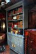 A Beautiful Hand Made Painted Book Case With Four Shelves Over Two Panelled Doors, Supported on Bracket Feet