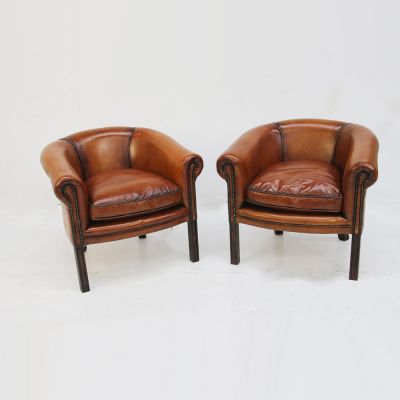 Pair of tan leather tub chairs