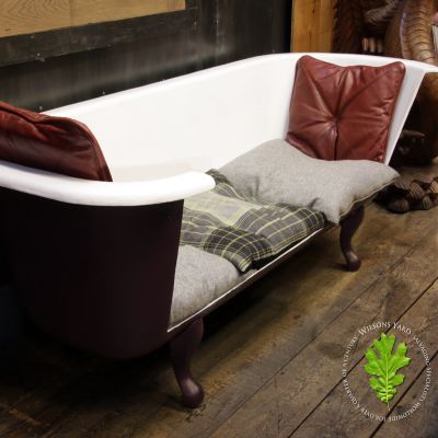 Funky  cast iron bath with claw feet converted into seat with cushions 