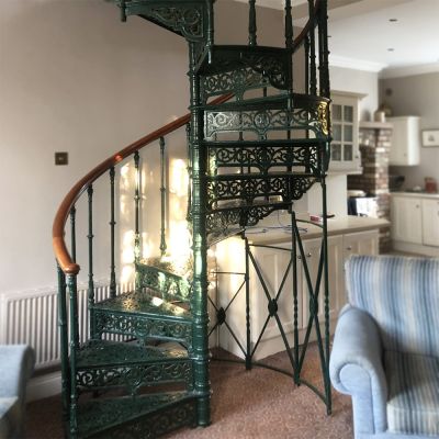 Original Victorian cast iron spiral staircase with intricate fleur de lys detailing