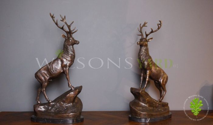 Pair of Bronze Reposing Stags on Mantle Plinths