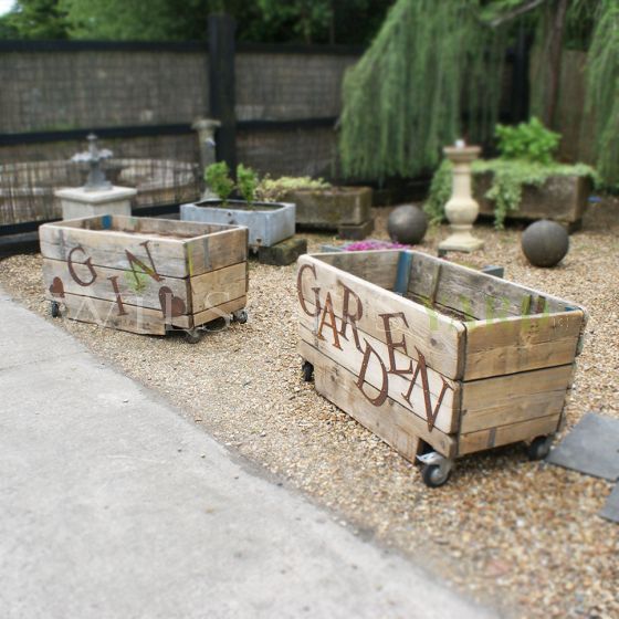 Vintage wooden garden planters on wheels