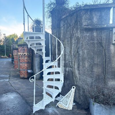 Original Victorian cast iron spiral staircase with intricate filigree treads 